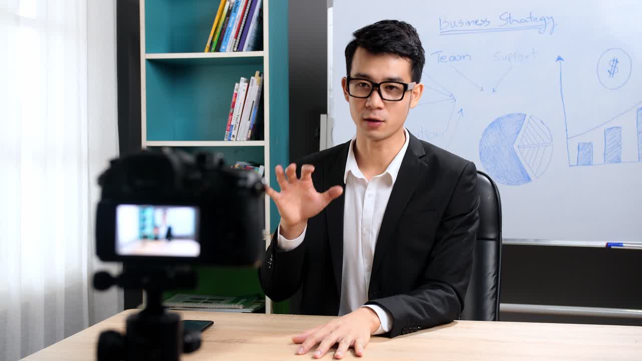 Asian Businessman Looking At Camera Talking About Company Strategy And Business Plan