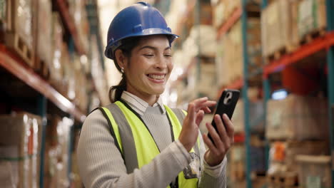 warehouse worker using mobile phone in a warehouse