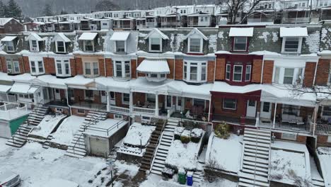 aerial flight towards row of houses in low income housing area of american city