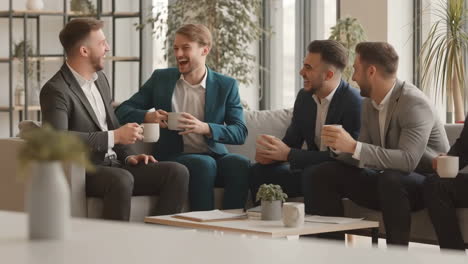 businessmen having a casual conversation in an office lounge