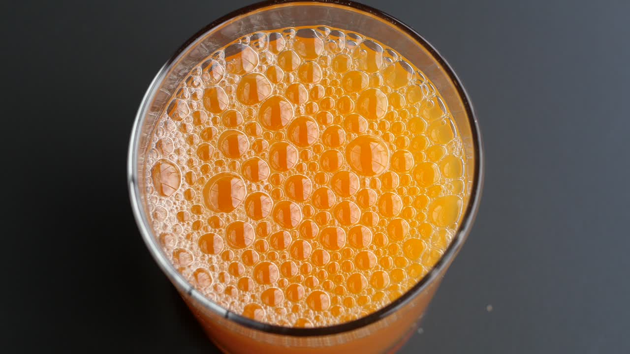 Orange Juice in a Glass with Bubbles