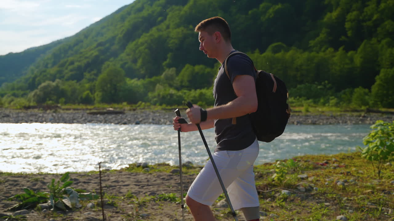 산책 막대기 와 인공 다리 를 들고 산 을 산책 하는 남자