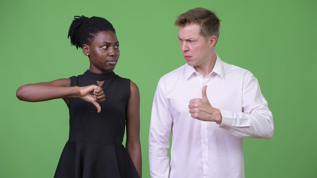 Two young multi-ethnic business couple having different choices together