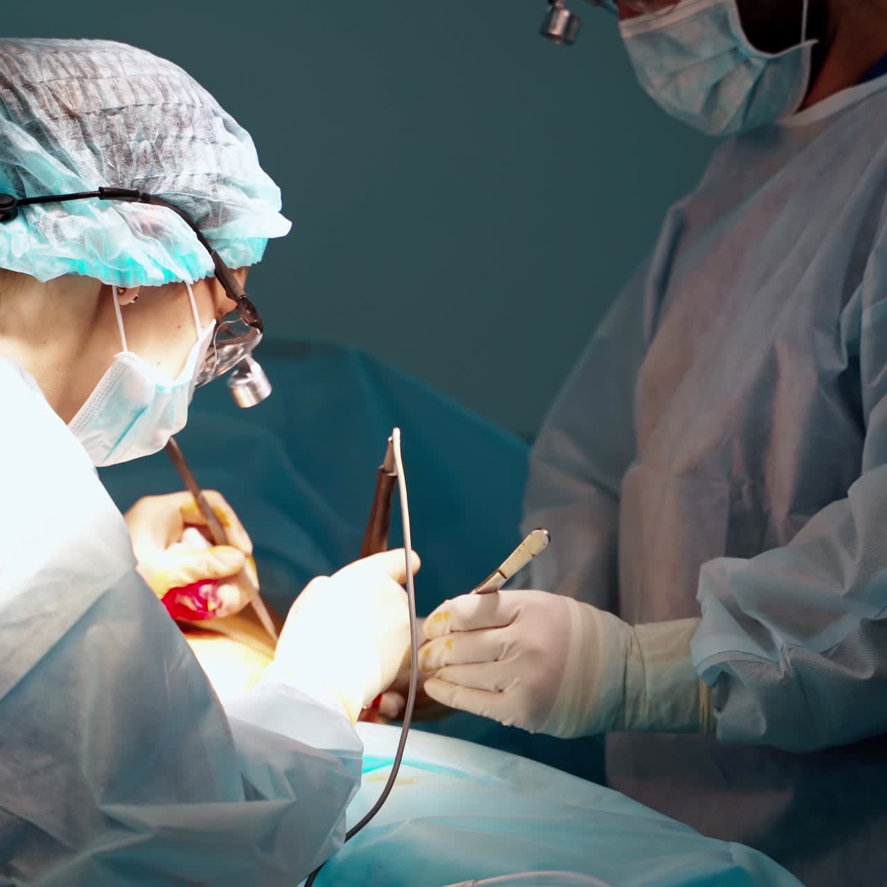 Surgeon and his assistant performing cosmetic surgery. Abdominoplasty plastic surgery. Body correction