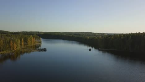 Lake-ferry-with-passengers,-clean-water,-deep-blue-sky,-autumn-trees