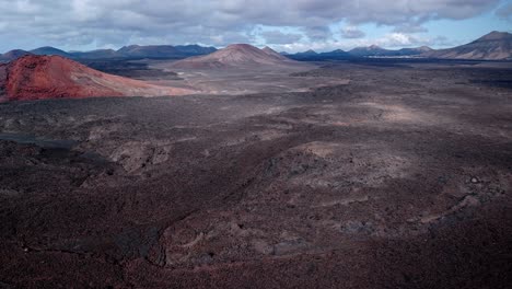 spectacular aerial drone footage of the volcanic landscape of timanfaya national park in lanzarote, canary islands.