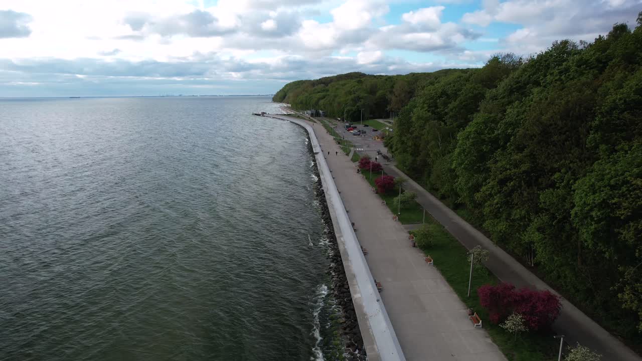 Footpath and bike lane along Baltic Sea coast. Promenade protected by seawall
