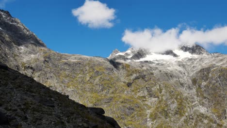 Panorama-shot-of-giant-mountains-covered-with-snow-on-the-peak-against-blue-sky-and-sunlight---Gertrude-Saddle-New-Zealand