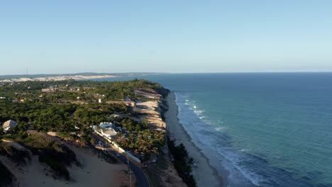 Rising-aerial-drone-shot-of-the-beautiful-tropical-Northeastern-Brazil-coastline-from-the-Cliffs-of-Cacimbinhas-in-Tibau-do-Sul-near-Pipa,-Rio-Grande-do-Norte-on-a-warm-sunny-summer-day