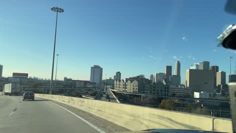 drive on the i45 exit to reveal the houston downtown at sunset. exit from texas 59 to tx 288. drive car passing downtown houston texas. drive a right lane with houston downtown scene in the background