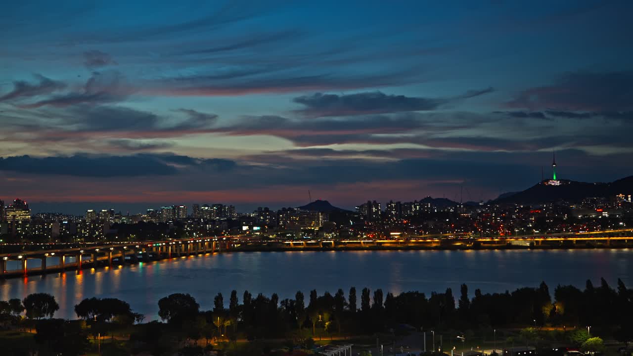 Night cityscape with illuminated bridge and skyline