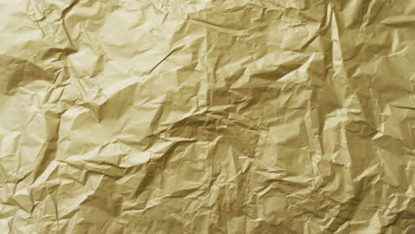 video of close up of crumpled yellow paper texture background