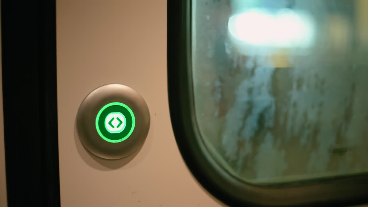 Close up of a man pushing a button to open the doors and people getting out of a train