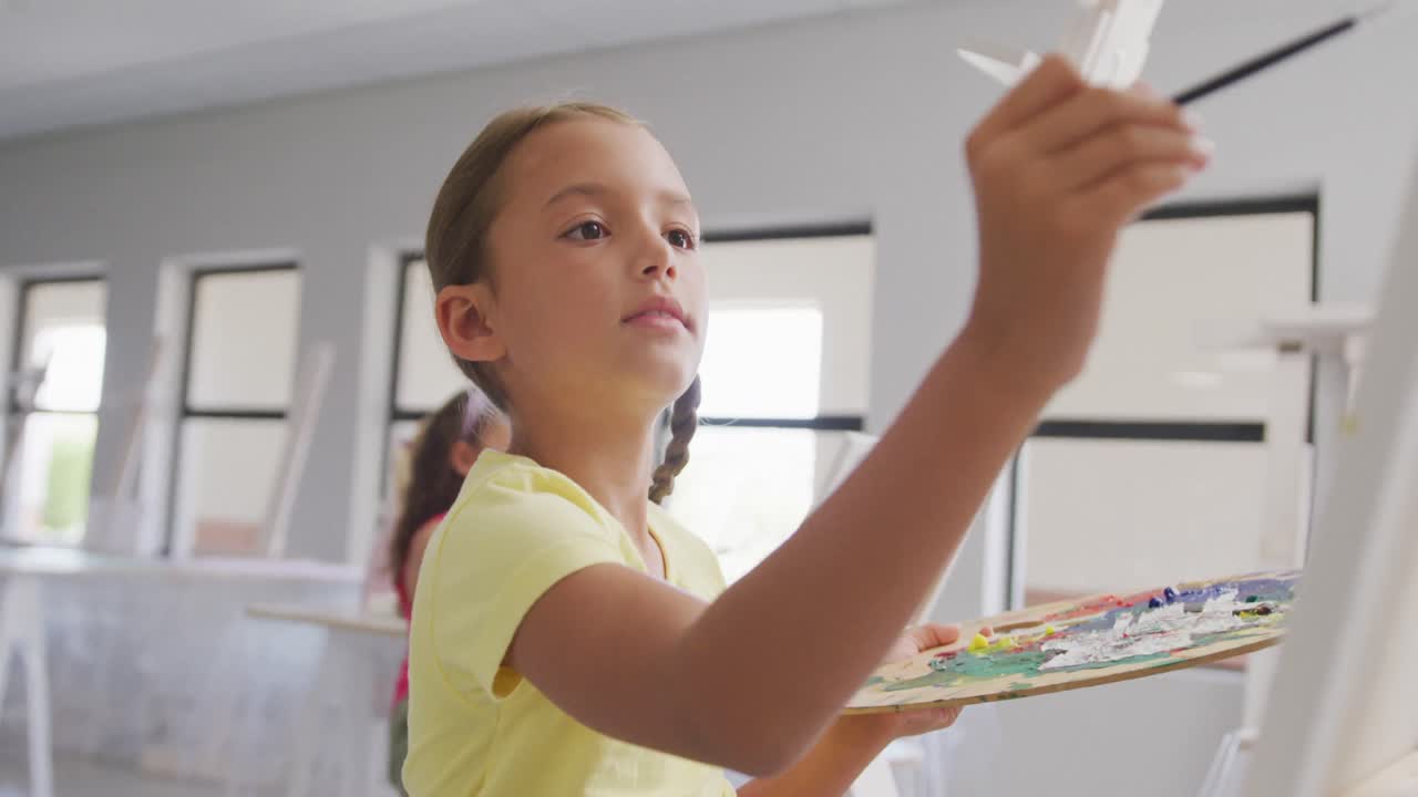 학교에서 미술 수업 중 초점을 맞춘 백인 소녀 그림의 비디오