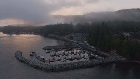 aerial view of a small secluded town on the pacific ocean coast during a cloudy summer sunrise