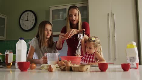 Mother-and-daughters-cooking-crepes-together