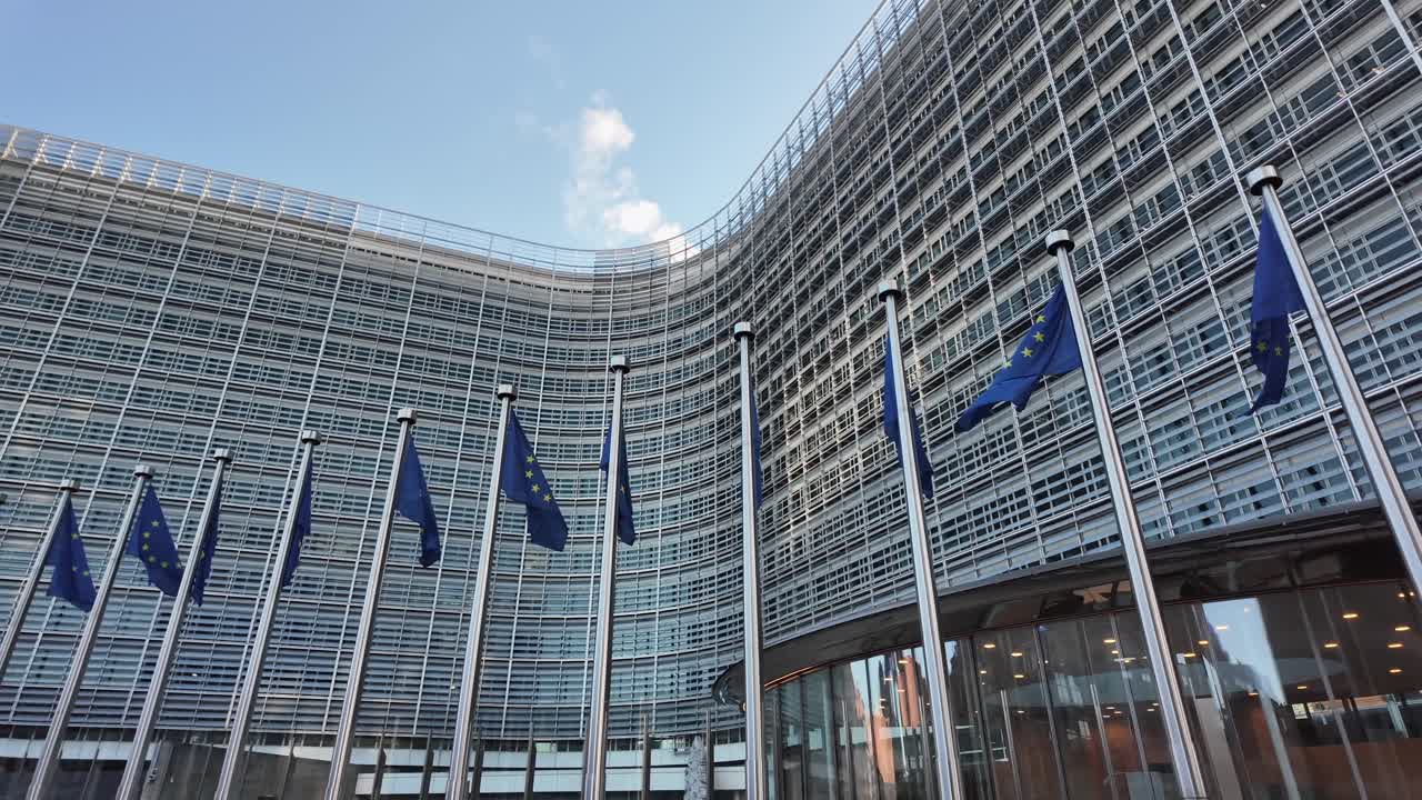 European Commission headquarters with EU flags in Brussels