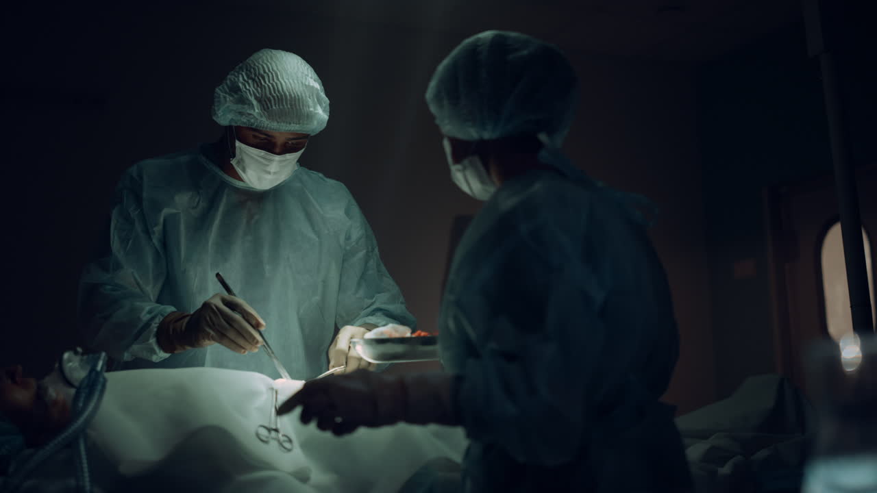 Doctors operating in emergency room. Cooperating medical workers saving patient.