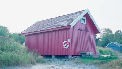 deslizarse más allá de la casa de botes rural con boya salvavidas
