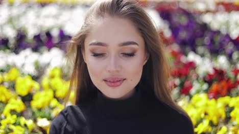 portrait of young and beautiful woman with makeup looking at camera