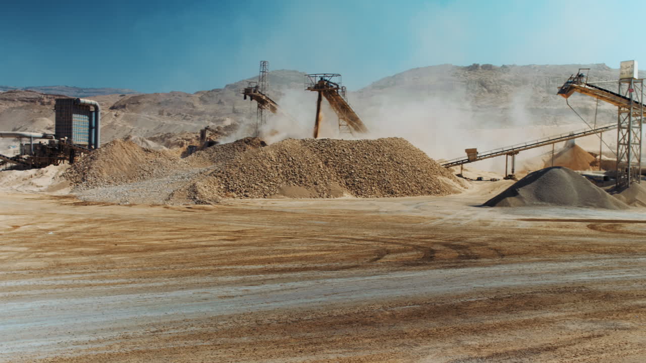 Industrial sand mining - Wide Shot - Pan Right for a mining machinery industrial area, Mining equipment working. 4K footage