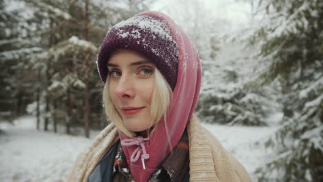 portrait of young beautiful woman in winter woods