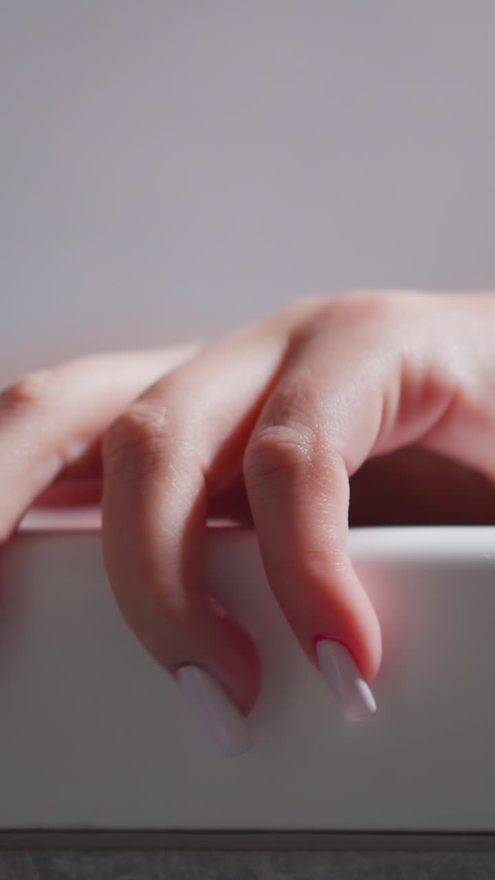 Woman hand on bathtub edge at home closeup. Lady enjoys recreational procedures bathing in luxury spa salon. Woman takes warm bath to relax body