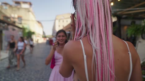 two women hugging in an urban scene