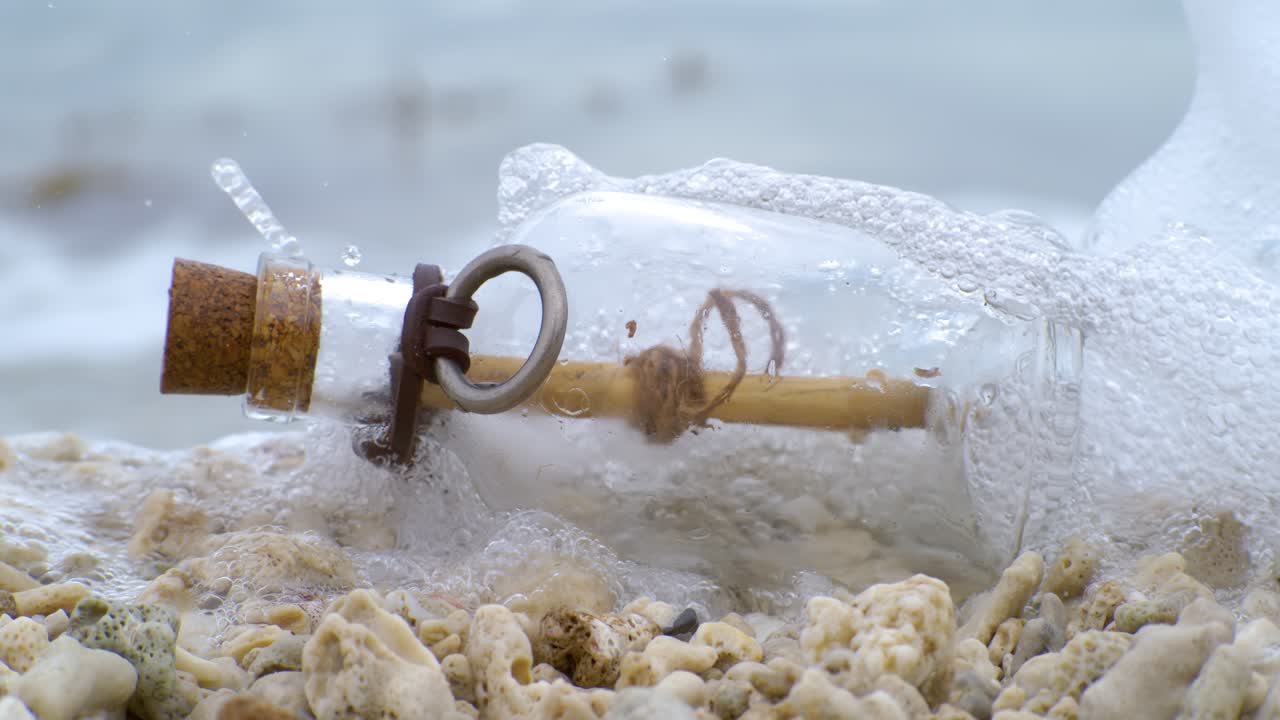 Message in the bottle on a sand beach. Shot on super slow motion camera 1000 fps