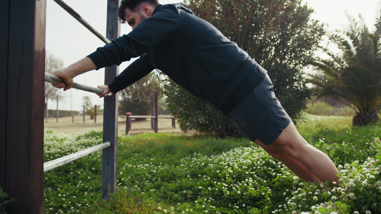 Man Works Out in Spring Outdoors Doing Push Ups