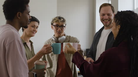 Diverse Colleagues Collaborate and Share a Celebratory Toast in the Office