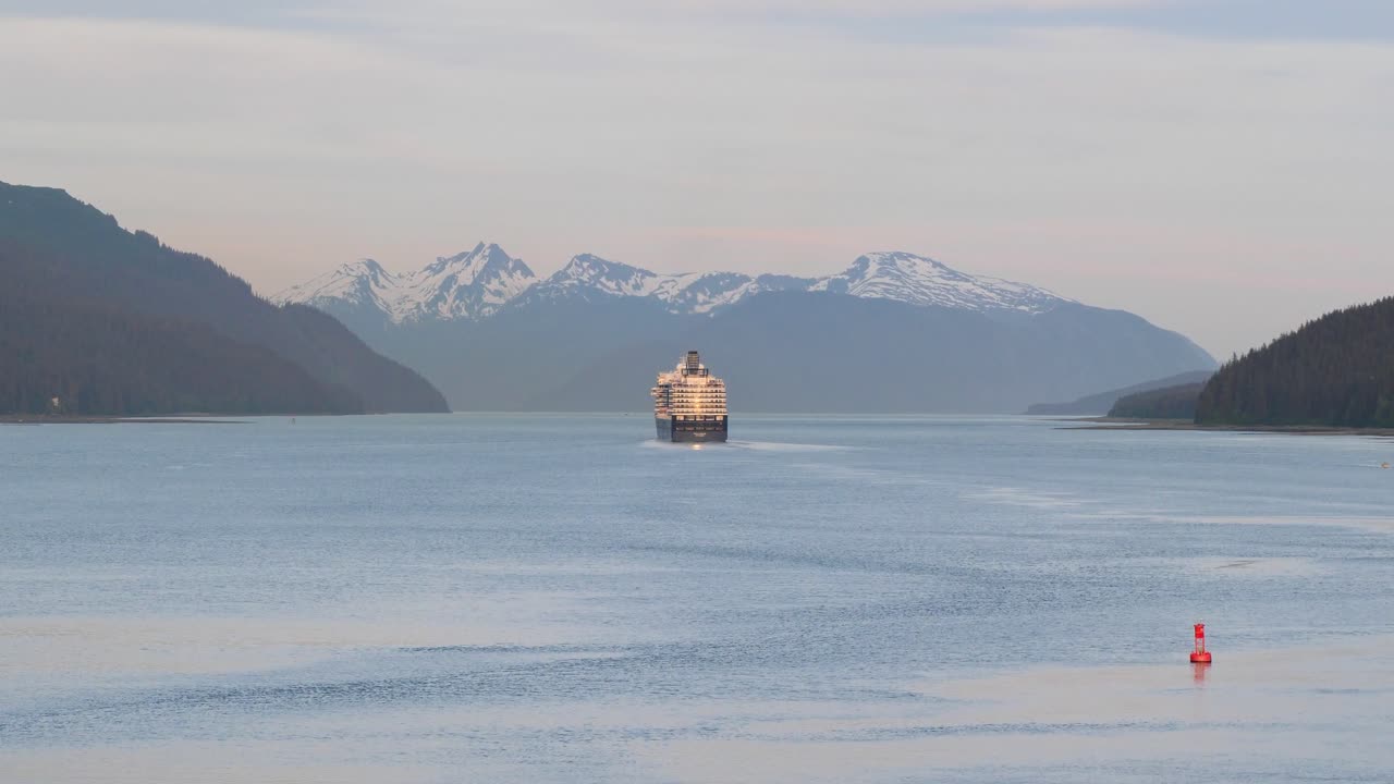 Navigating Gastineau Channel at sunset. Cruise ship leaving Juneau, Alaska.