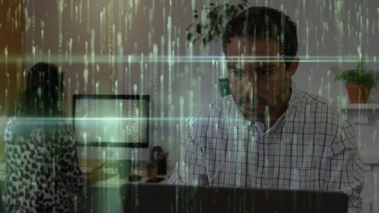 Man typing on laptop analyzing data starting code overlay in tech office for data visualization