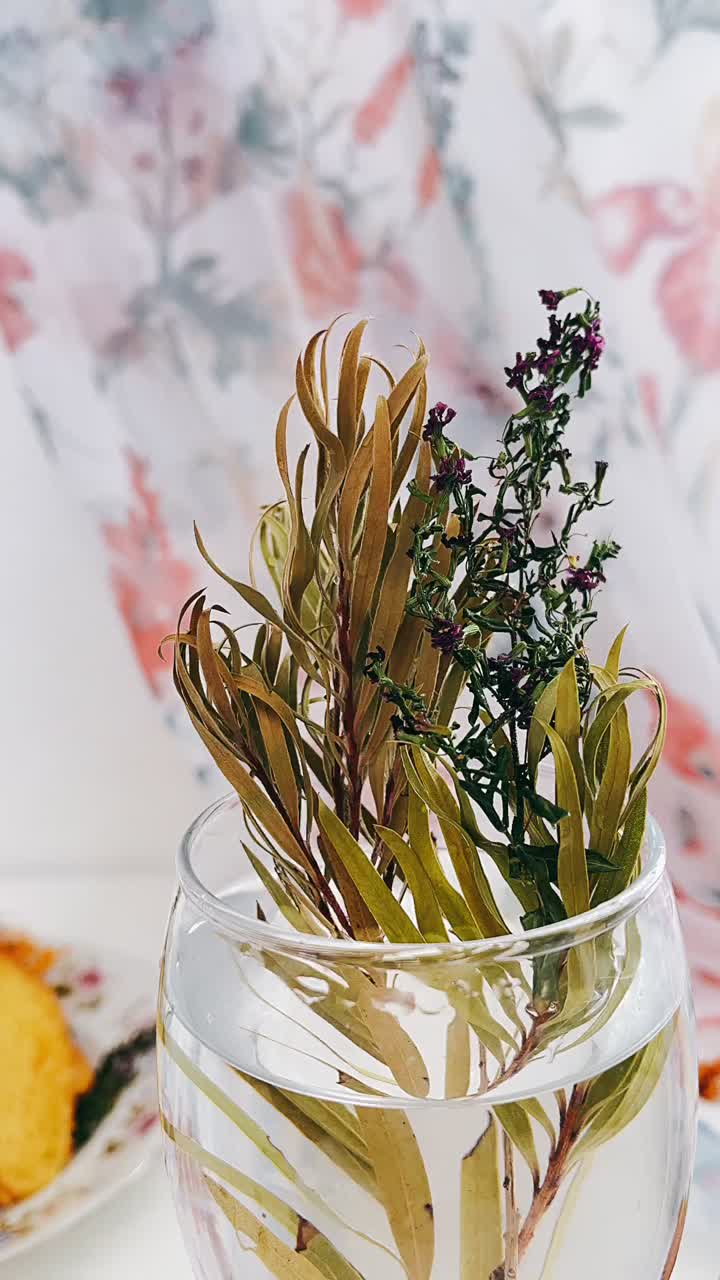 Dried Flowers in a Glass Vase with Cake