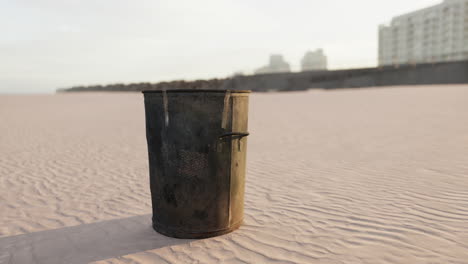 gray metal garbage bin or trash can on the beach