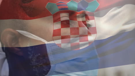 Animation-Der-Flagge-Kroatiens,-Die-Während-Der-Covid-19-Pandemie-über-Einem-Mann-Mit-Gesichtsmaske-Weht