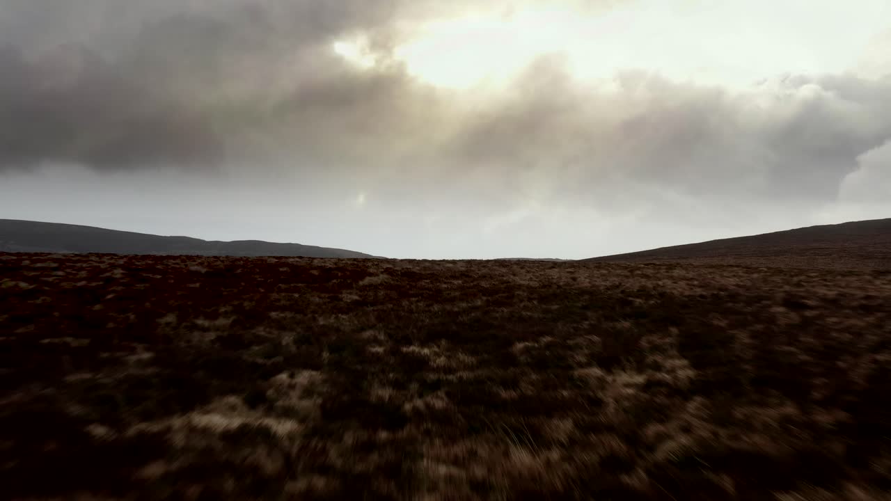 Spectacular Aerial view of Sally Gap, Wicklow Mountains, Ireland, February 2020. Drone pushes forward slowly low to the ground, over a peat bog landscape.