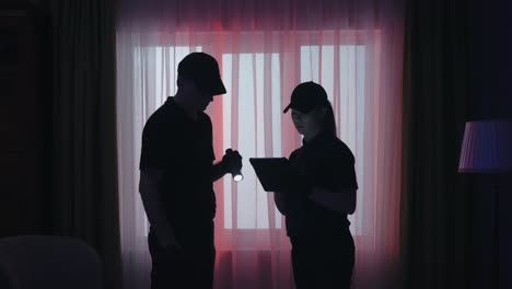 security personnel inspecting a home at night