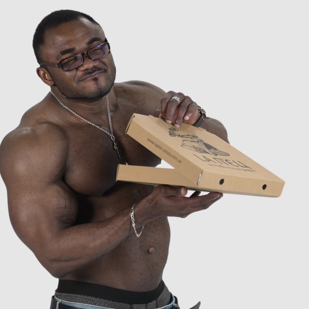 Muscular man holding pizza. Athletic handsome naked body of african man with pizza