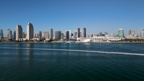 speedboat cruising in the bay along downtown san diego skyline in san diego, california