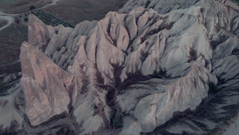 drone shot capturing cappadocia’s dramatic rocky terrain from above