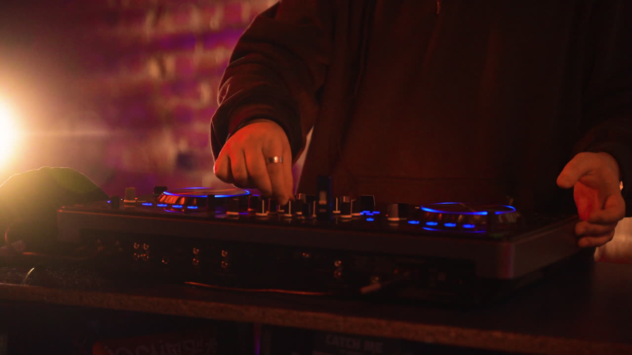 Man with black cap djing at the disco