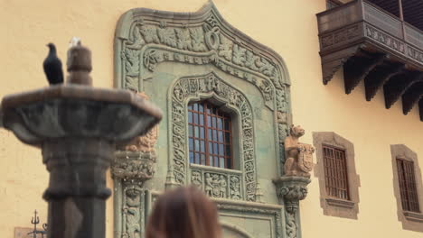 fantastic shot of tourist admiring casa de colon in las palmas de gran canaria