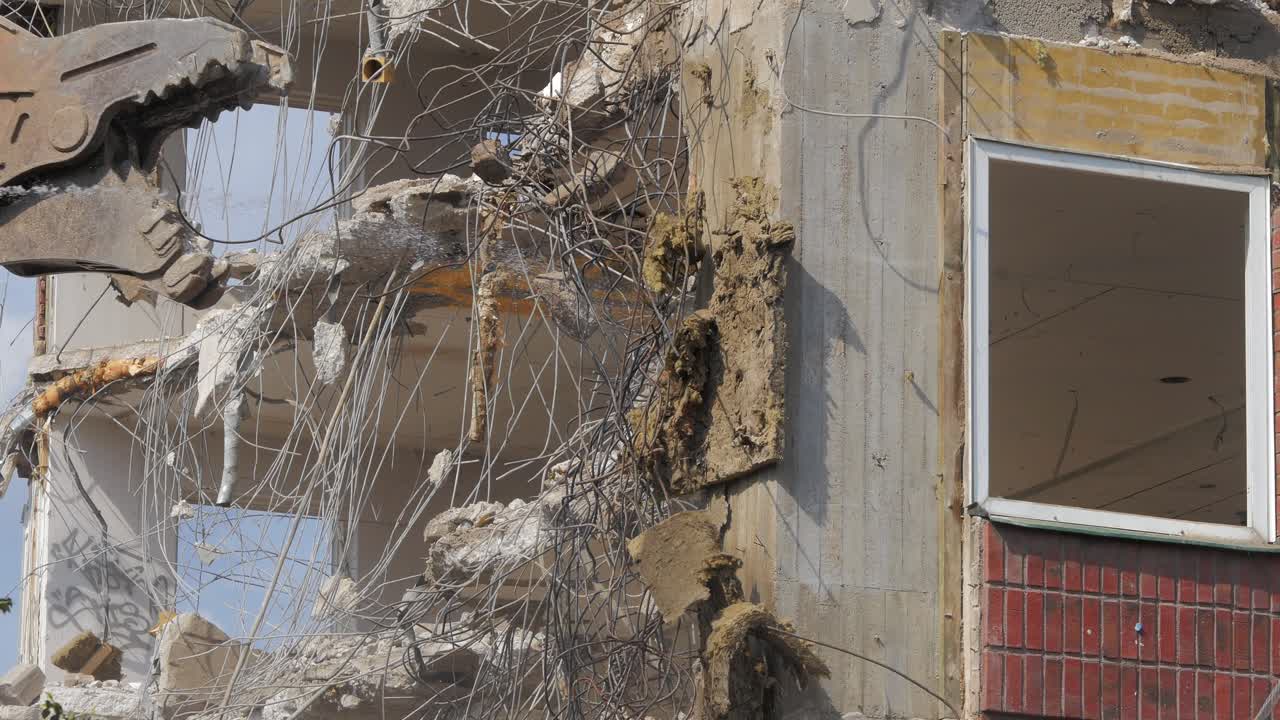 Stockholm, Sweden - 2021.08.13: Demolition of an office building in Stockholm. Heavy machinery can be seen tearing down the interior of the building.