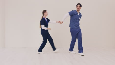 couple, happy and nurse dancing together