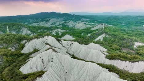 Aerial-birds-eye-shot-of-asian-badlands-during-golden-sunset-in-Taiwan---Moonscape,-Lunarscape-Landscape,-Tianliao-Moon-World,-田寮月世??