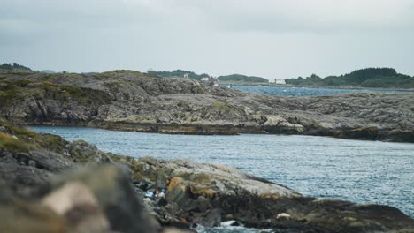rocky coastline with ocean waves and people
