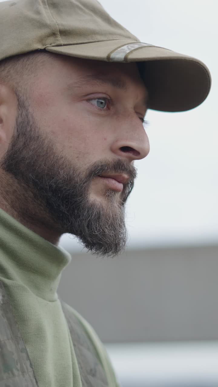 Portrait of a soldier with a beard wearing a cap