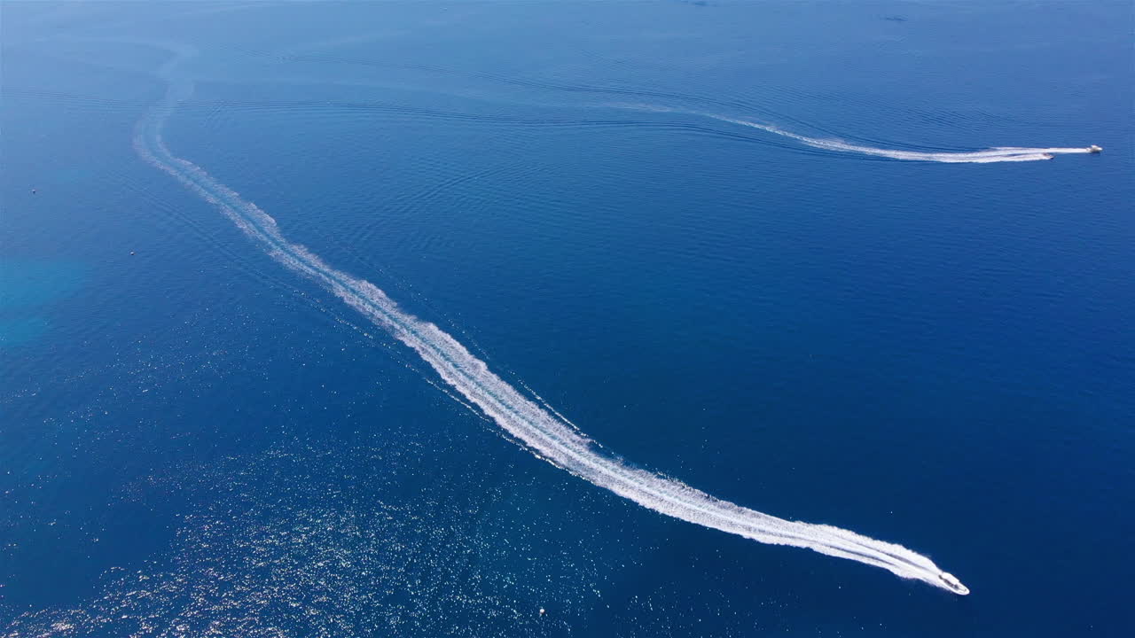 Aerial footage over Speed boat sailing in fast speed at the large blue sea