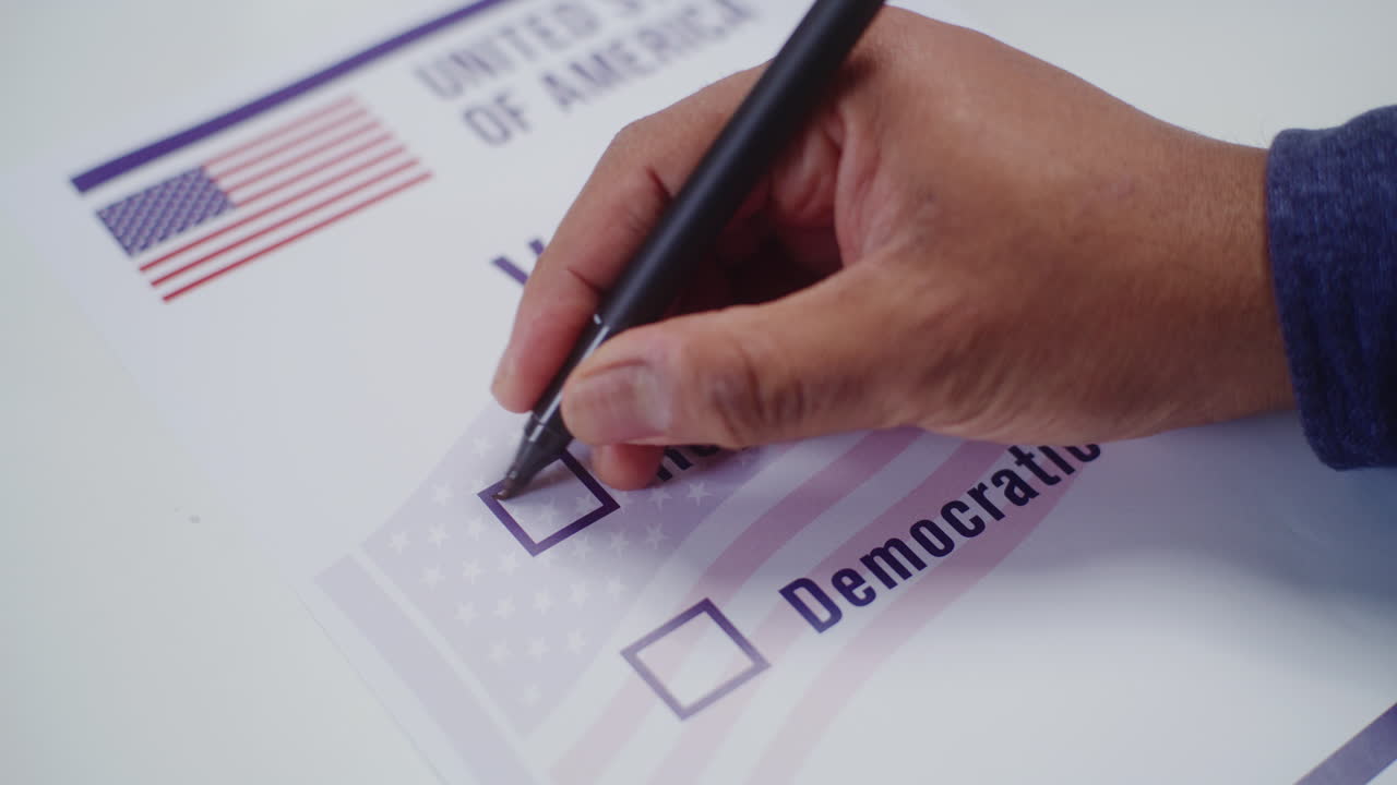 Anonymous us Citizen Votes for Republican Party in Voting Booth Anonymous us Citizen Votes for Republican Party at Polling Station Close up of African American Man Filling out Paper Bulletin in Voting Booth National Election Day in the United States Civic Duty